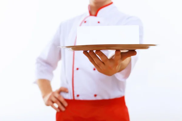 Koken houdt een leeg bakje — Stockfoto