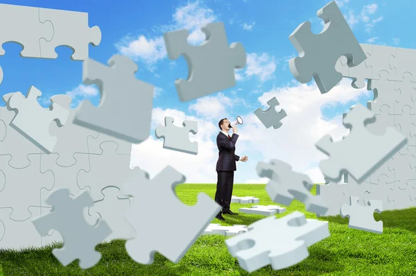 Businessman with a puzzle pieces — Stock Photo, Image
