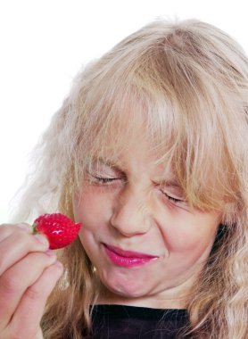 Girl is eating strawberry. clipart