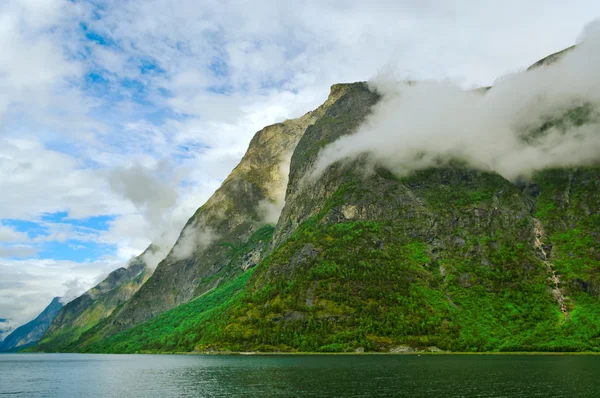 Clouds above fjord`s mountains. — Stock Photo, Image
