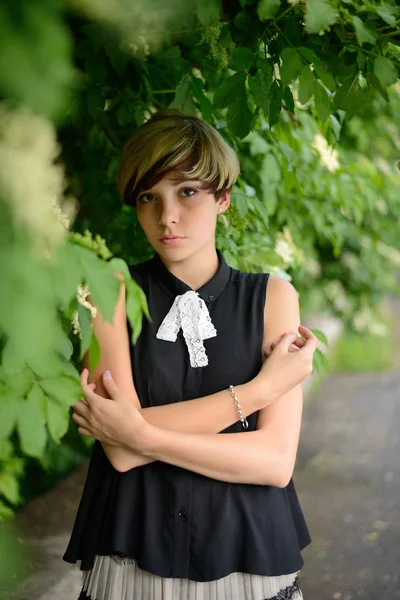 Beautiful girl posing in green leaves — Stock Image Beautiful girl posing in green leaves Royalty Free Stock Photos