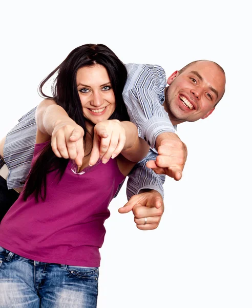 Portrait of happy young couple pointing at you over white backgr — Stock Photo, Image