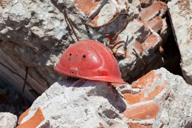 Old construction helmet over ruins clipart