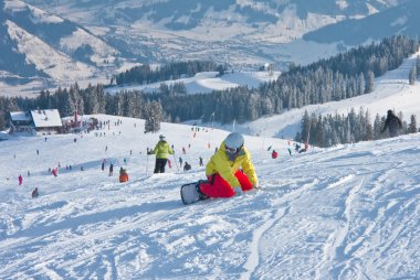 Snowboarder in the mountains of Zell am See. Austria clipart