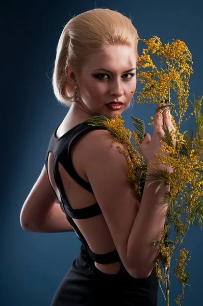 Blonde woman with a branch — Stock Photo, Image