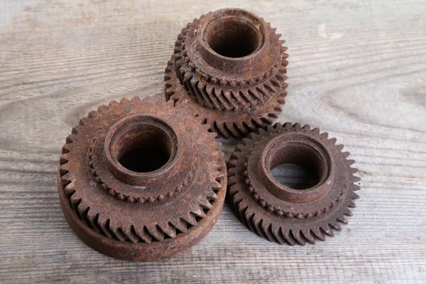 Rusty iron gear wheels on a boards — Stock Photo, Image
