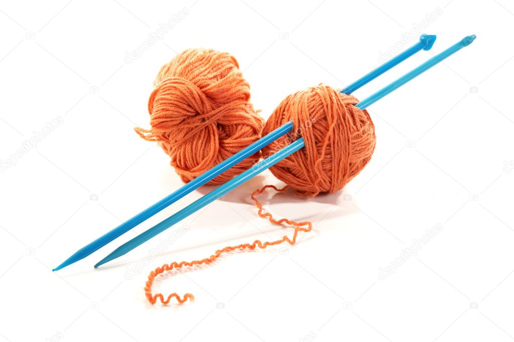 Balls of a yarn knitting spokes on white background