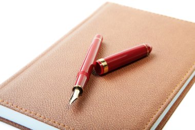 Fountain pen close-up and leather organizer isolated on a white clipart