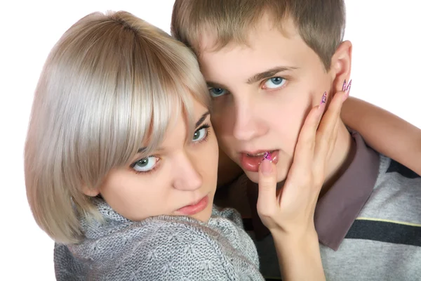 The girl embraces the young man on a white — Stock Photo, Image