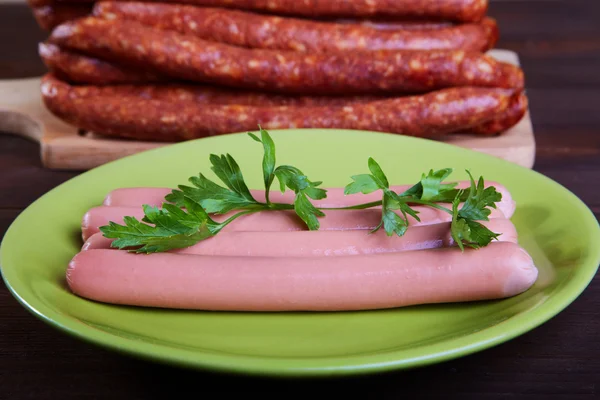 Sausage and sausages on an wooden table — Stock Photo, Image