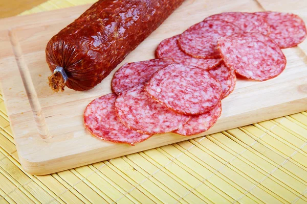 The smoked sausage cut on slices — Stock Photo, Image