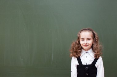 Schoolgirl near a Chalkboard clipart