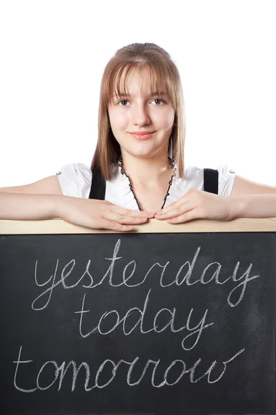 Girl about a blackboard with inscriptions today, tomorrow, yeste — Stock Photo, Image