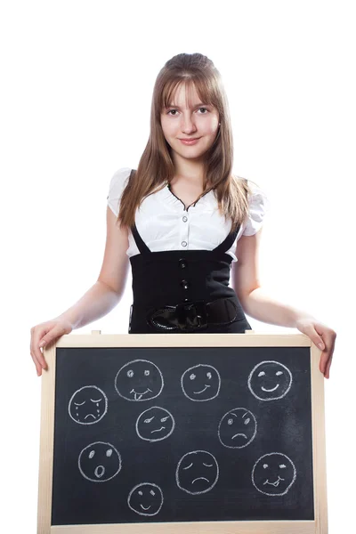 Lány megmutatja egy táblára, boldog és szomorú arcok a corkboard — Stock Fotó
