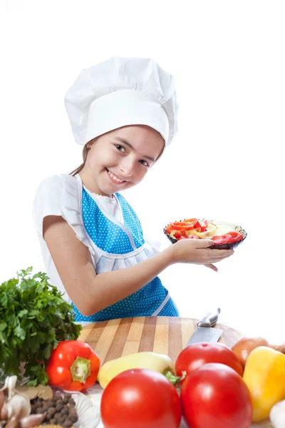 Little chef cook with a plate of salad and vegetables — Stock Photo, Image