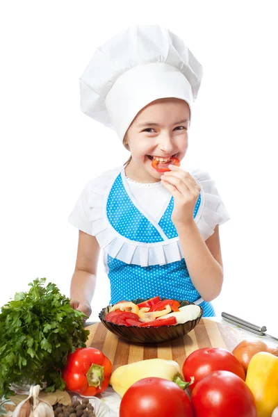 Happy little chef cook tastes salad with Bell Pepper — Stock Photo, Image
