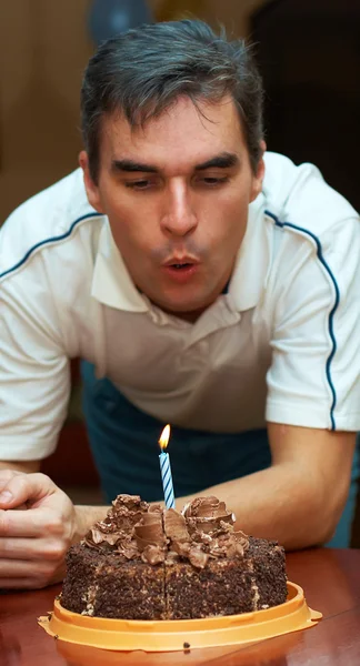 stock image Man blowing out birthday candle