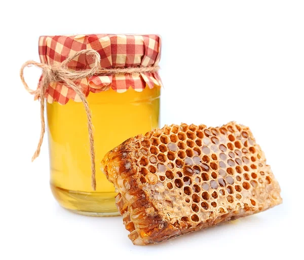 Jar of honey and honey honeycombs — Stock Photo, Image