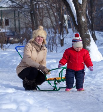 Mother with toddler in winter clipart