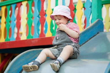 Two-year child on slide clipart