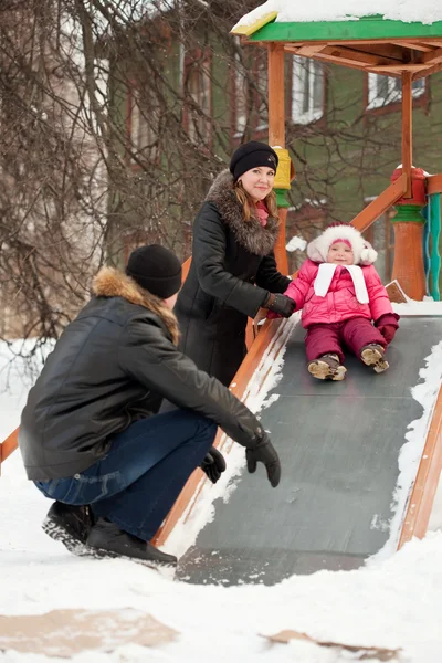 Parents with toddler on slide — Stock Photo, Image