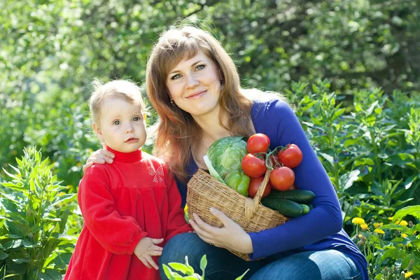 Donna felice e bambino con raccolto di verdure — Foto Stock