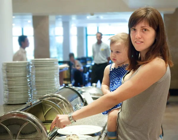 Woman with child in buffet — Stock Photo, Image