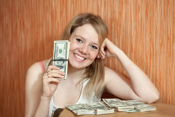 Happy girl with US dollars in home — Stock Photo, Image