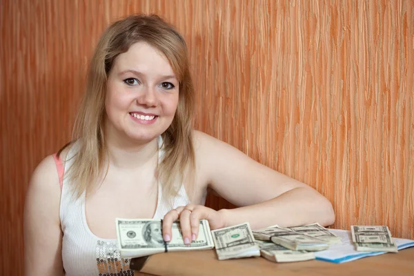 Happy girl with US dollars in home — Stock Photo, Image