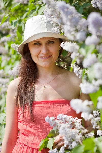 Woman in lilac plant — Stock Photo, Image