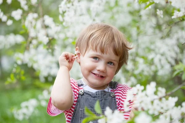 Baby girl in spring garden — Stock Photo, Image