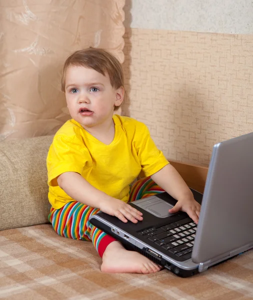 Маленькая девочка сидит с ноутбуком — стоковое фото