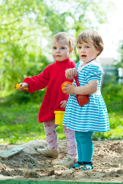 Two girls in sandbox — Stock Photo, Image