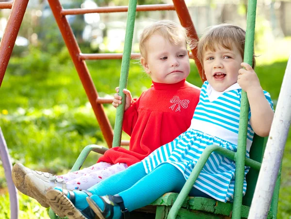 Two children on swing — Stock Photo, Image