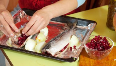 Cook making mackerel with cranberries clipart