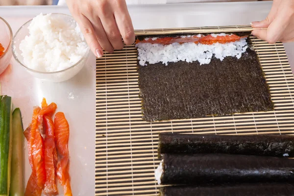 Cozinheiro fazendo rolos de sushi — Fotografia de Stock