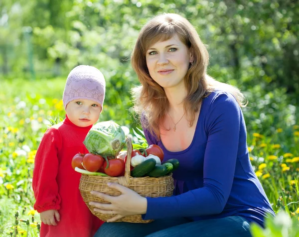 Frau und Baby mit geerntetem Gemüse — Stockfoto