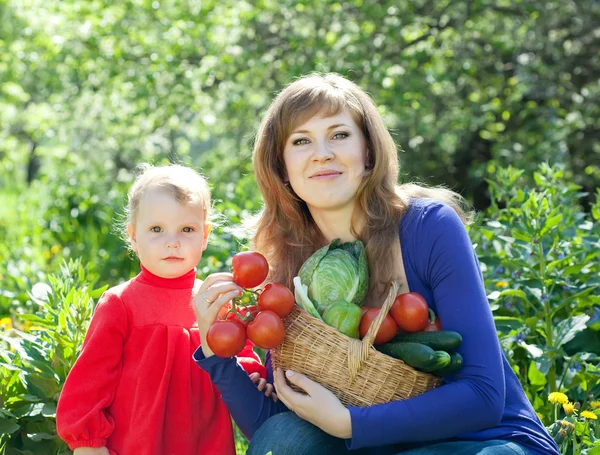 Женщина и ребенок с урожаем овощей — стоковое фото