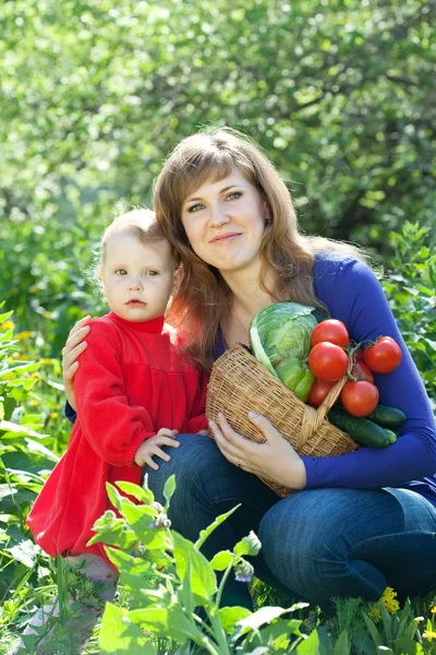 Woman and baby with vegetables — Stock Photo, Image