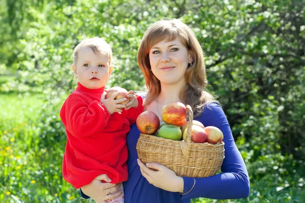 Счастливая женщина и ребенок с яблоками — стоковое фото