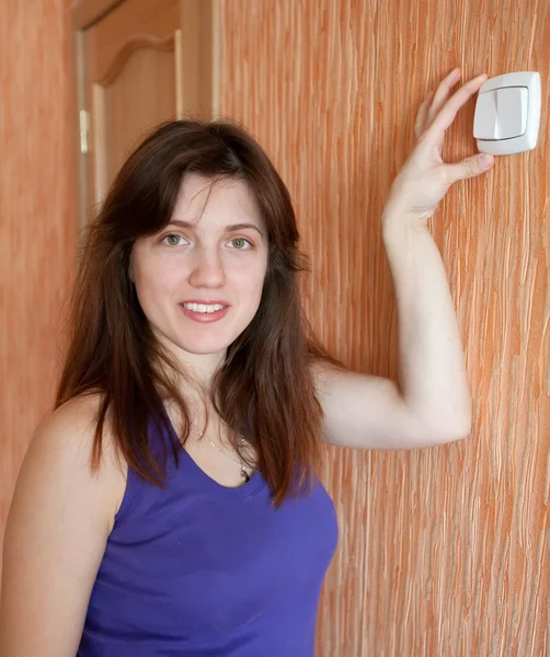 Woman with switch in home — Stock Photo, Image