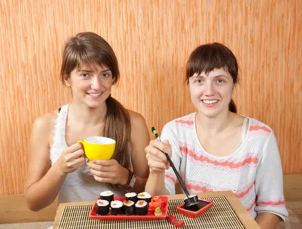 Women eating sushi rolls — Stock Photo, Image