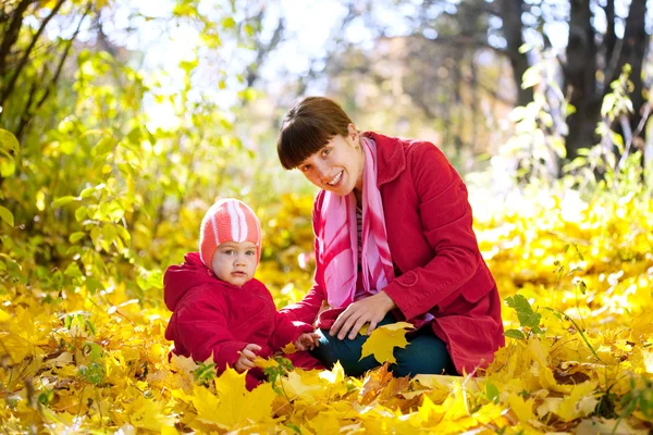 Mother and baby in autumn park — Stok fotoğraf