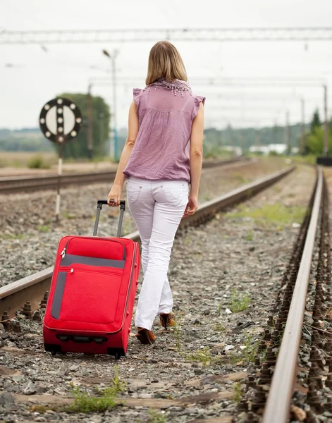 Rear view of woman walking on rail — Stock Photo, Image