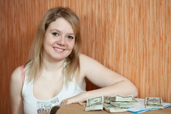 Happy girl with US dollars in home interior — Stock Photo, Image