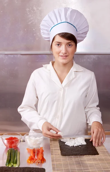 Cook woman making sushi rolls — Stock Photo, Image