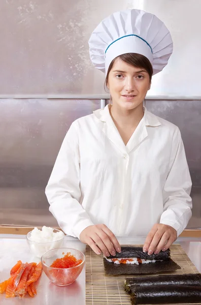 stock image Woman making japanese sushi rolls