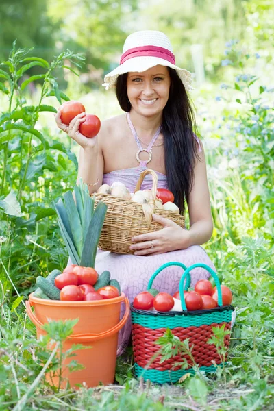 Happy woman with harvested vegetables — Stock Photo, Image