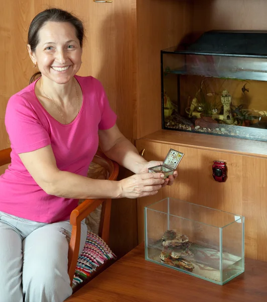 Woman with aquariums at home — Stok fotoğraf