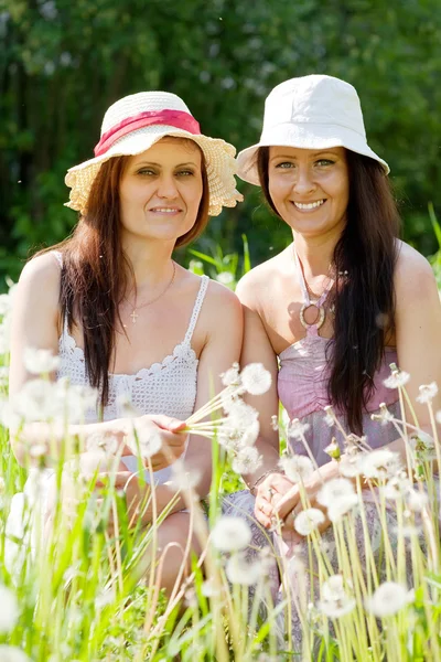 Women in dandelion plant — Stock Photo, Image